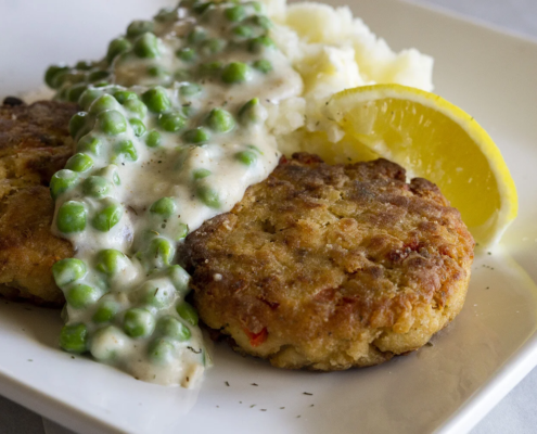 Salmon Cakes dish with creamed peas